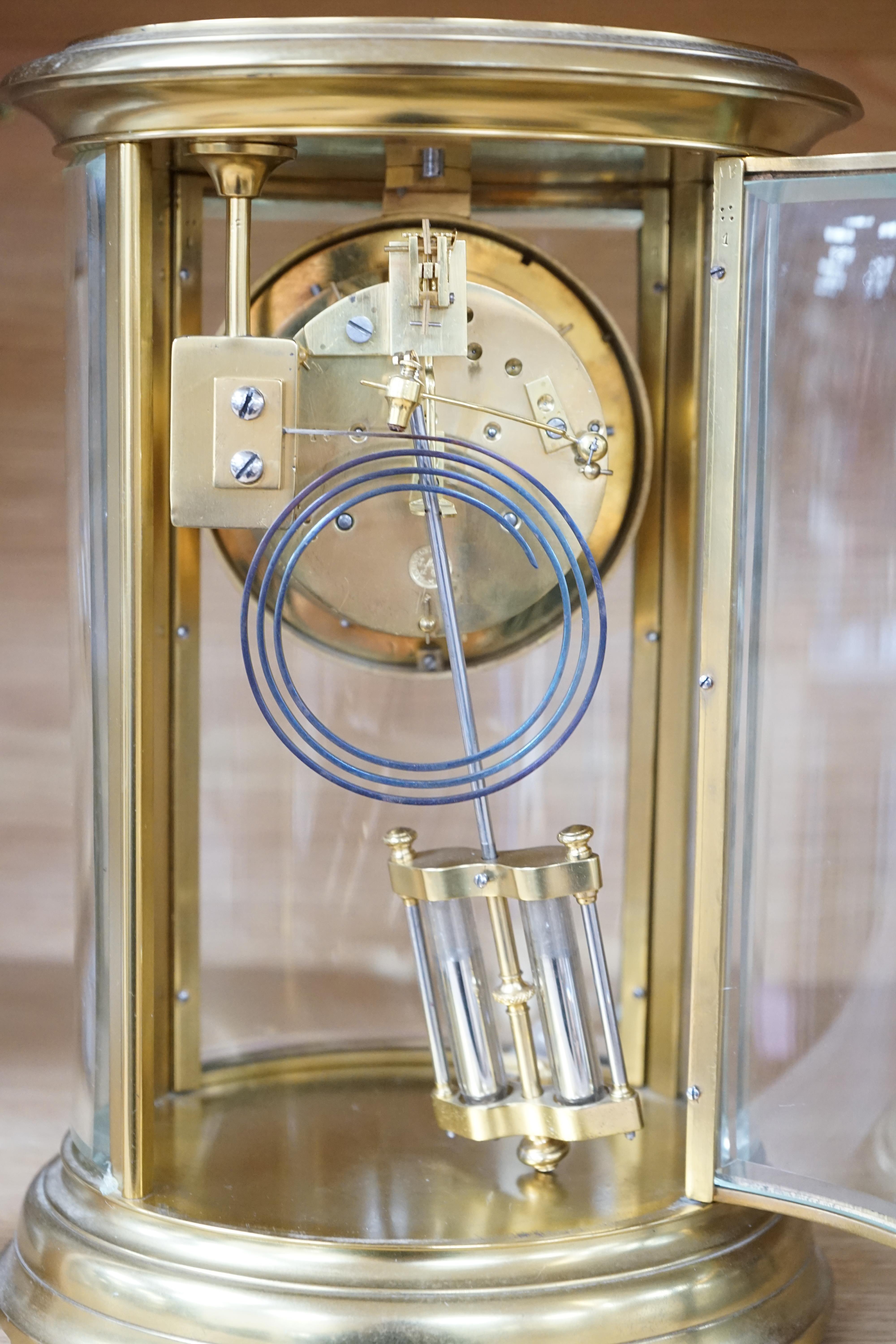 A 19th century French gilt brass oval four glass mantel clock with Brocot escapement, 30cm high. Condition - good